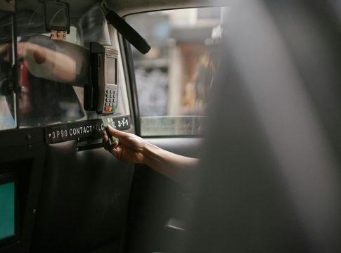 Car keys dangling over a calculator showing high monthly payments.
