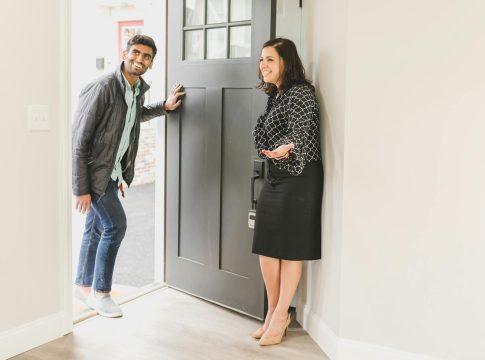 A person looking stressed while holding house keys near a 
