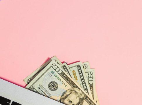 Magnifying glass over a laptop screen showing a 