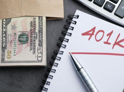 Magnifying glass over a 401k document highlighting fine print details.