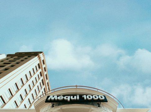 Woman looking stressed while calculating expenses on a budget.