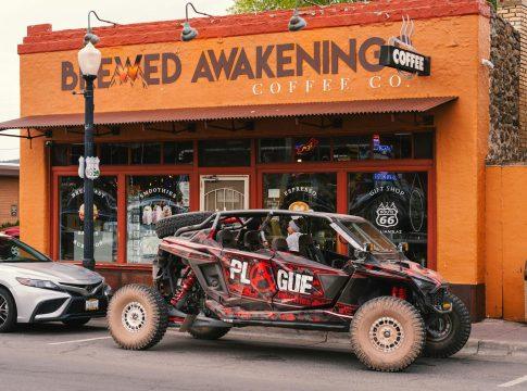 A person pouring coffee from a French press into a mug.