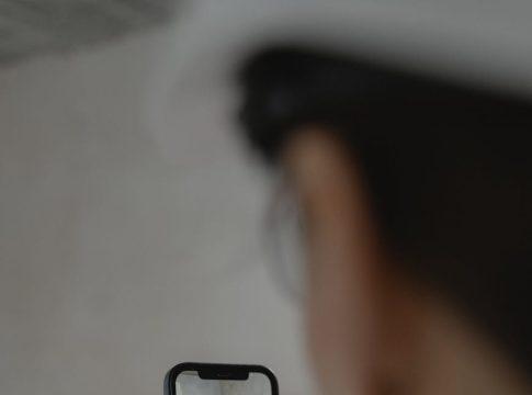 Woman looking thoughtfully at a laptop showing travel budget data.