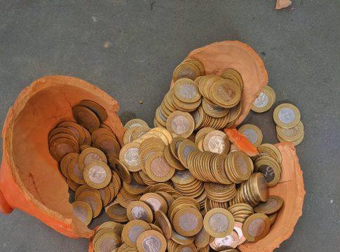Woman smiling while reviewing finances on a laptop, symbolizing financial comfort.