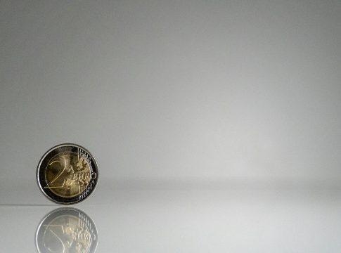 Woman looking frustrated while reviewing a complex budget spreadsheet.